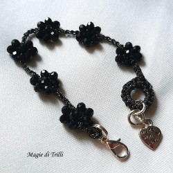Braccialetto donna con fiori di cristalli neri intrecciati con filo per gioielli argentato